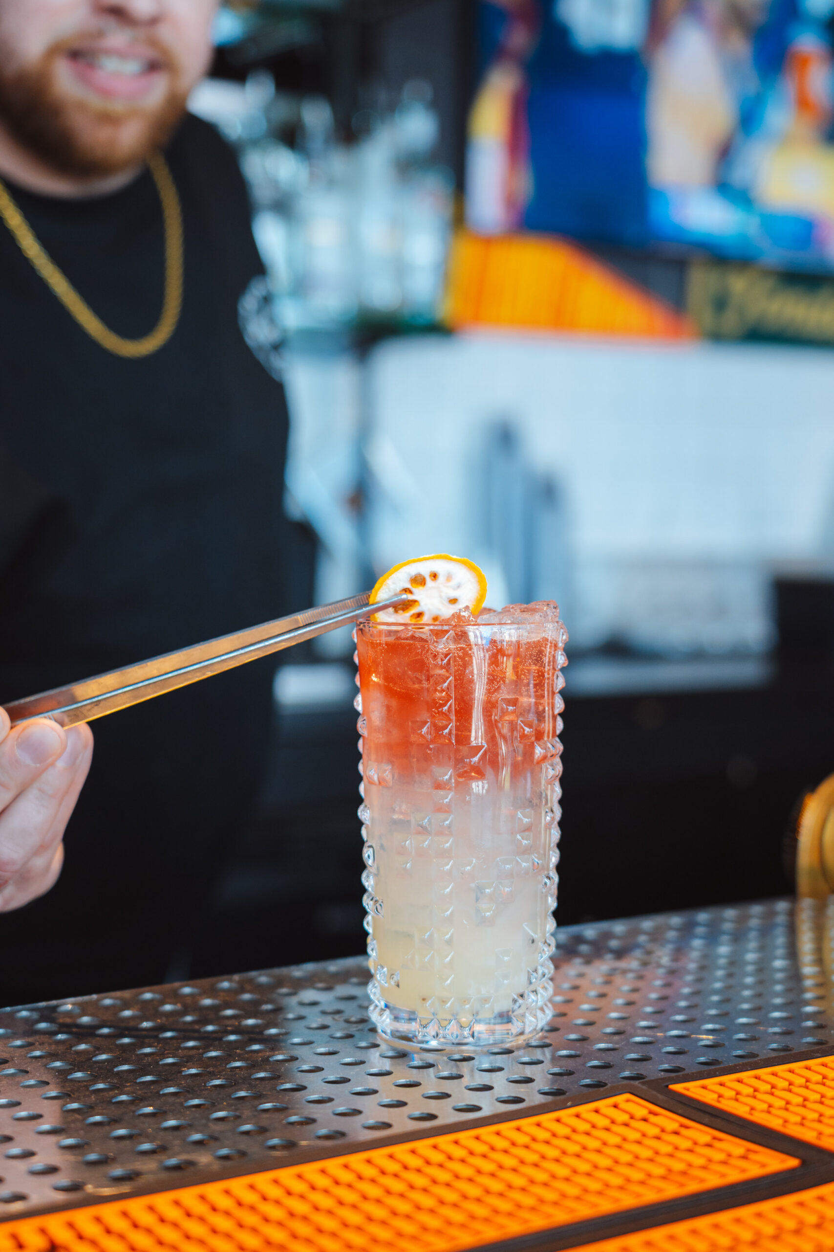Cocktail in Portland being garnished with orange slice