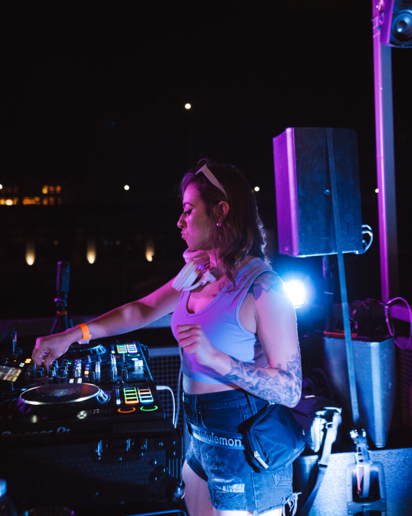 Shay Baca, female DJ wearing shorts and tank top at music venue called Wonderlove in Portland
