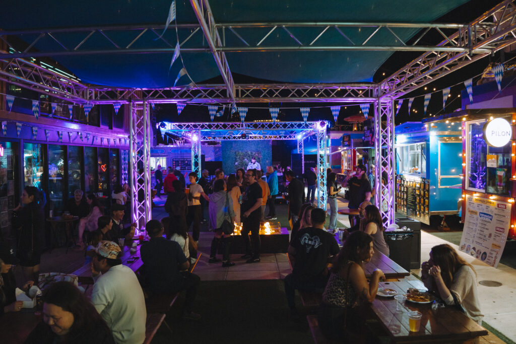 groups of men and women conversing with one another over cocktails and drinks at Wonderlove food truck pod in Portland Oregon
